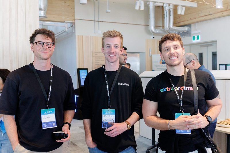 Three founders in company t-shirts, including KiwiFibre and Extraordinary, standing together at NZVC Portfolio Day 2025