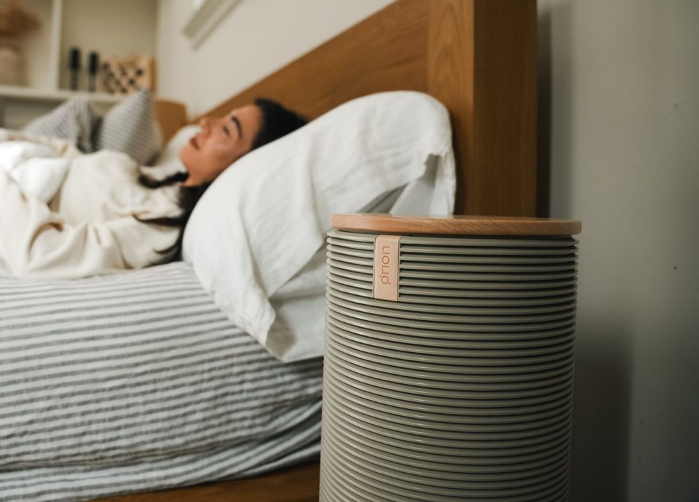 A sleeper in bed beside the Orion bedside tower