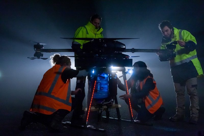 The Pyper Vision crew preparing a drone at night under work lights